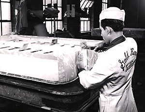A craftsman making a Gold Bond mattress, circa 1950.